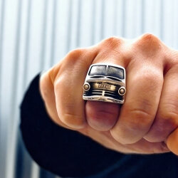 Handcrafted silver ring shaped like a classic car front, worn on a hand