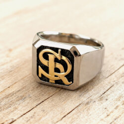 Solid two-tone 18k gold signet ring with custom RS monogram on a dark background